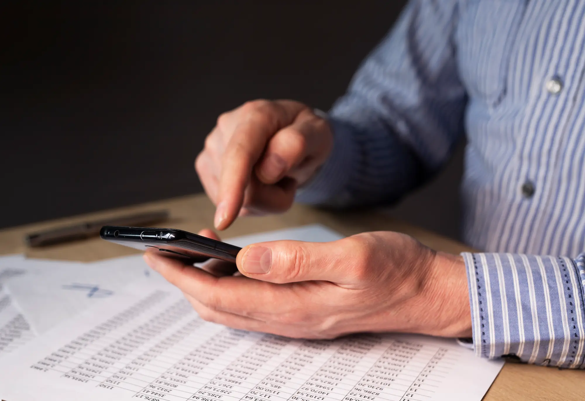 Man checking a phone number on his smartphone