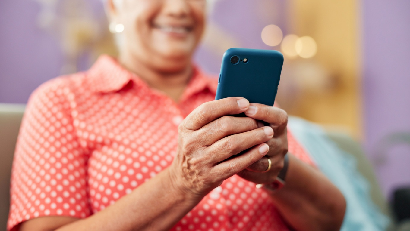 Smiling woman using a smartphone for reverse white pages lookup.