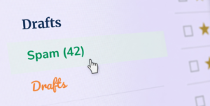 Cursor points at Spam in an email folder, illustrating how to stop spam emails.