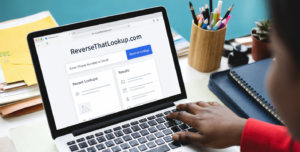 Person typing on a laptop, illustrating how to keep email address private.