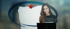 Woman at a laptop beside a blank note graphic, use linkedin to find address context.