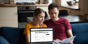 Couple reviews documents beside a laptop about credit freeze after identity theft.