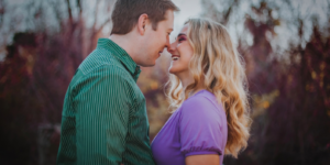 Smiling couple facing each other outdoors, for is hinge a good dating app.