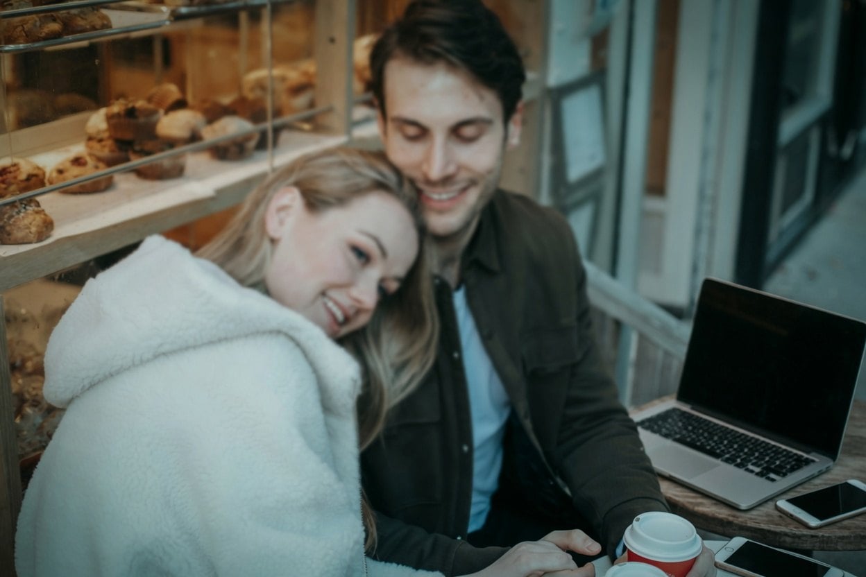 A happy couple enjoying a coffee break at a bakery