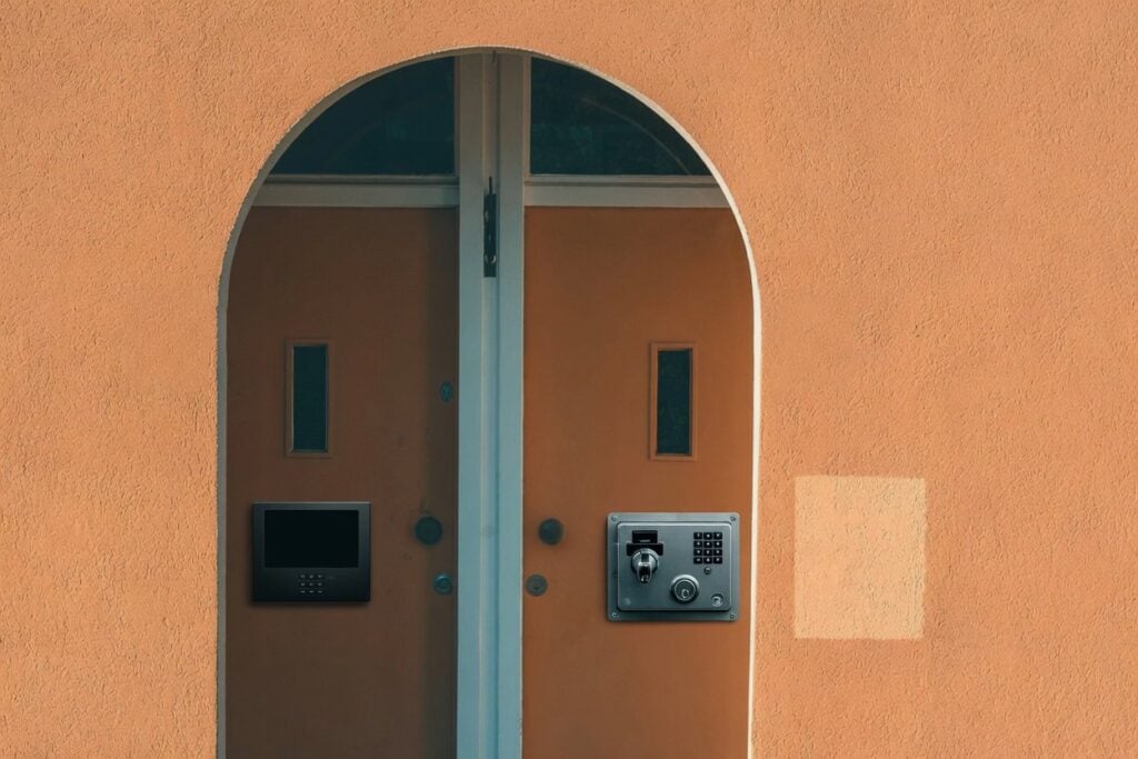 Arched doorway with two secured doors, illustrating differences between freeze and lock.