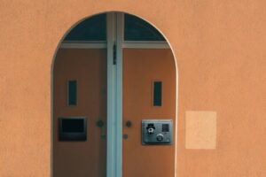 Arched doorway with two secured doors, illustrating differences between freeze and lock.
